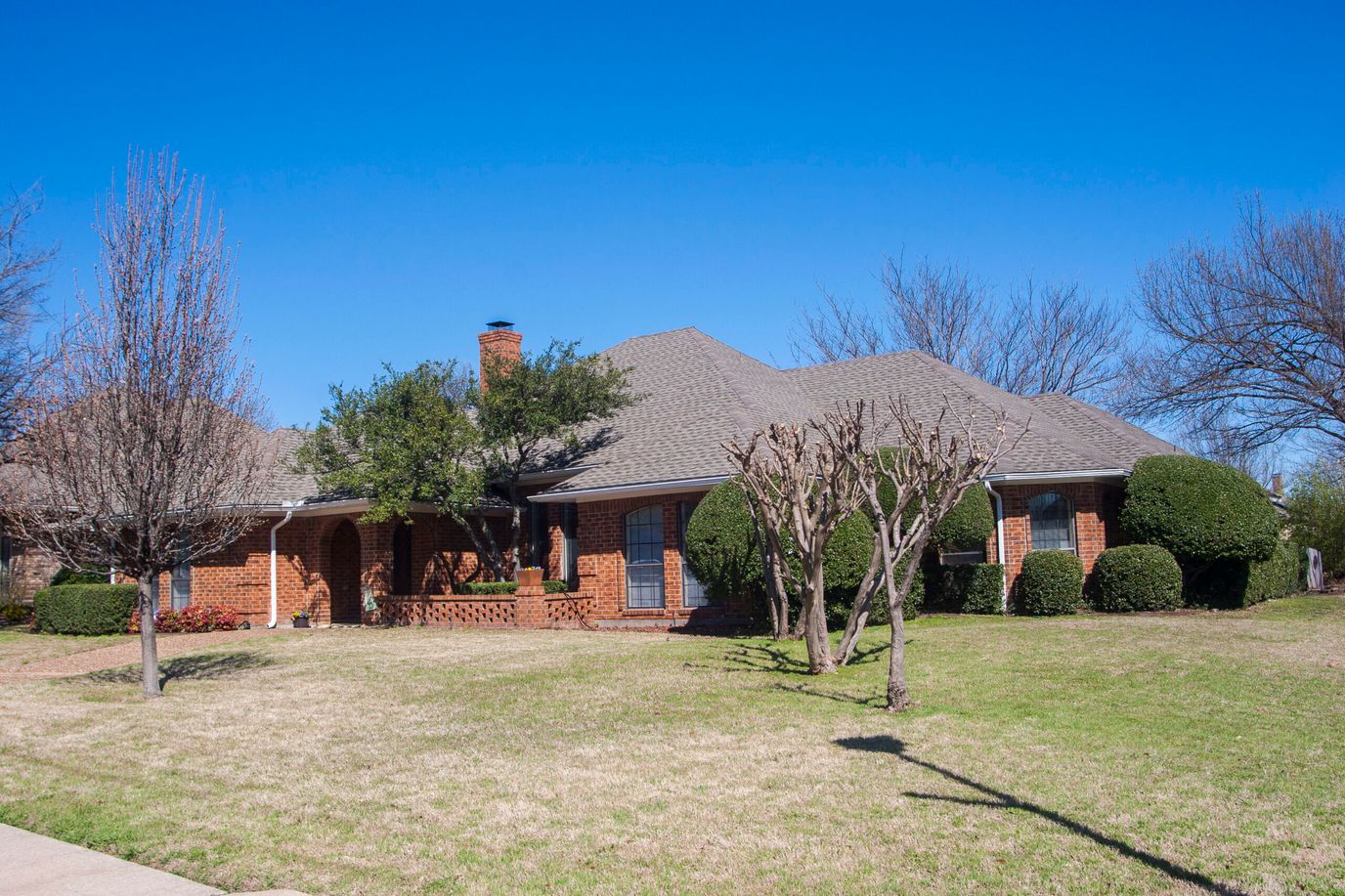 Exterior view of a brick building surrounded by trees