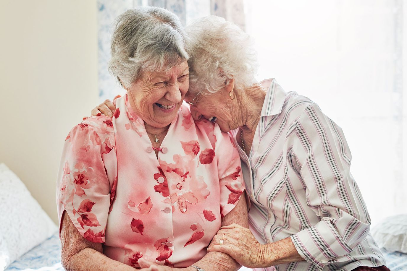 Legacy of the Meadows, assisted living in Dewitt, IA — Two smiling elderly women sharing a joyful moment