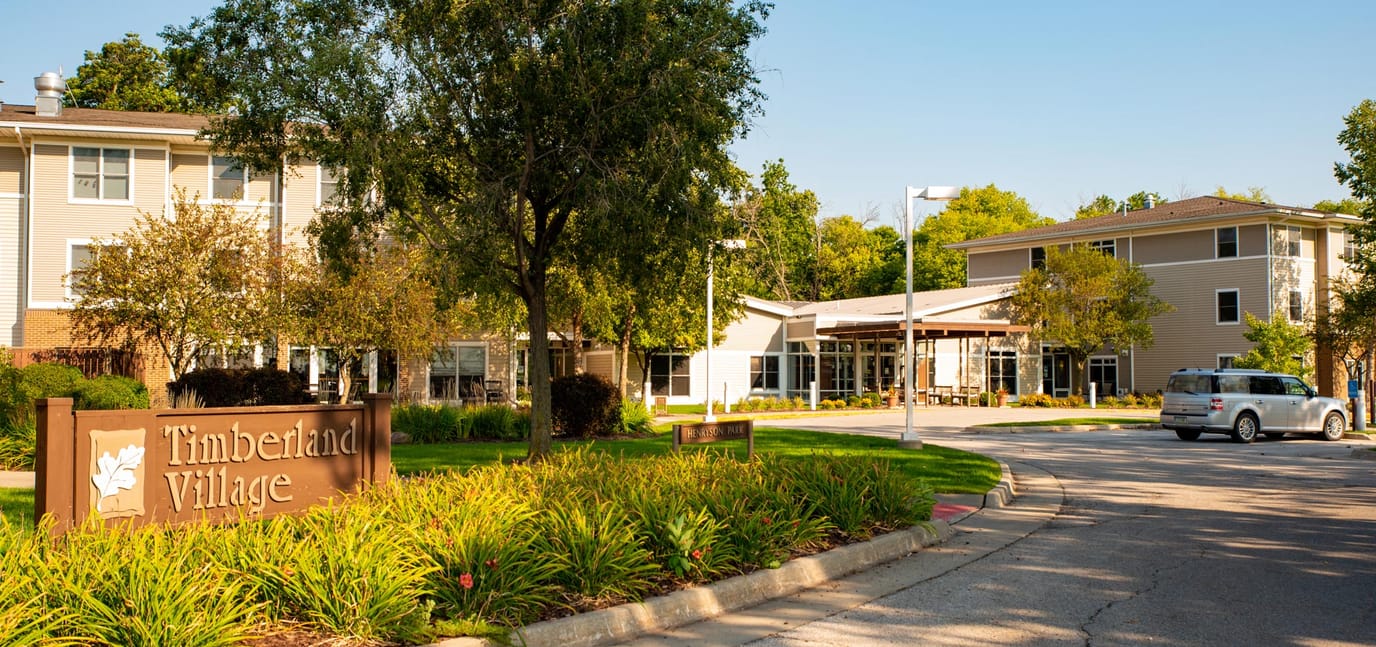 Exterior view of Timberland Village with signage