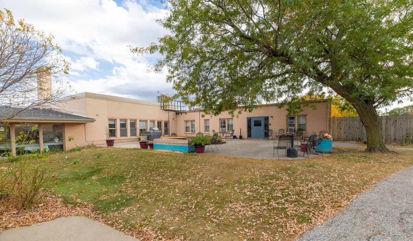 Exterior view of the facility with outdoor seating