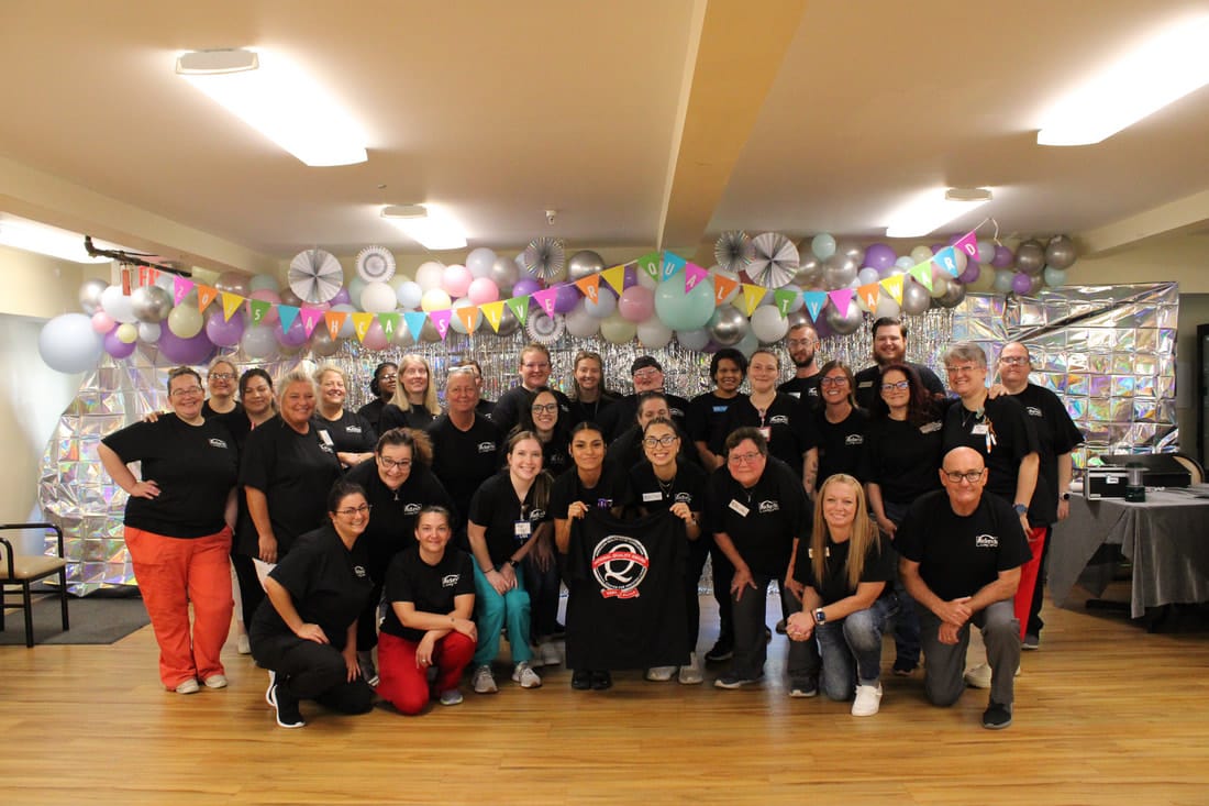 Staff and residents celebrating in a vibrant common area