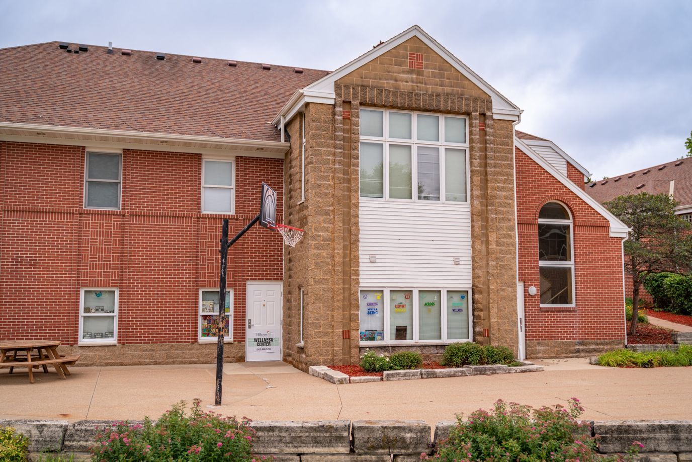 Exterior view of a senior living facility with outdoor seating