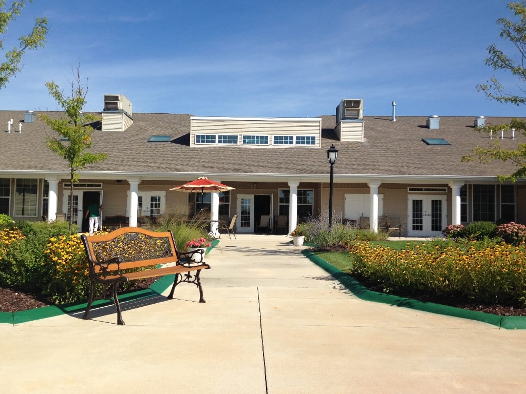 Exterior view of a senior living facility with garden area