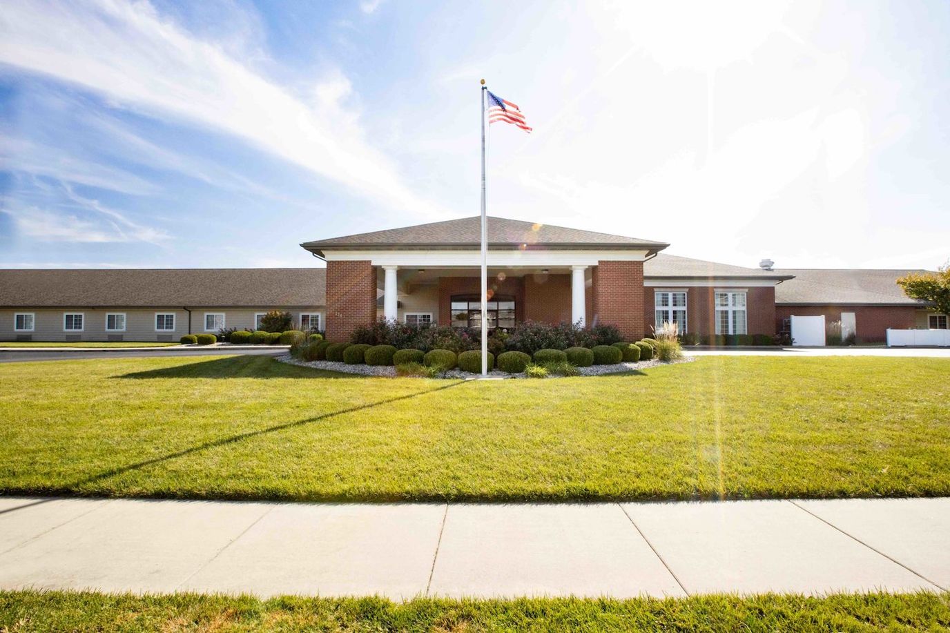 Facade of Cedarhurst of Highland with landscaped entrance