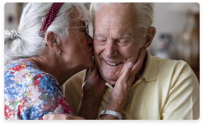 An elderly couple sharing a joyful moment.