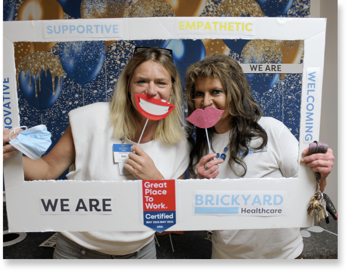Staff members celebrating with photo props at an event
