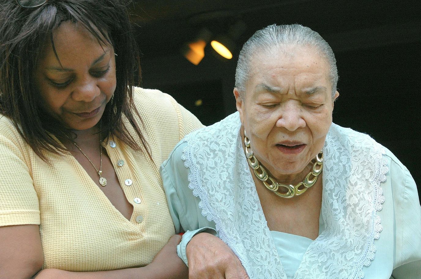 A staff member assisting a resident outdoors