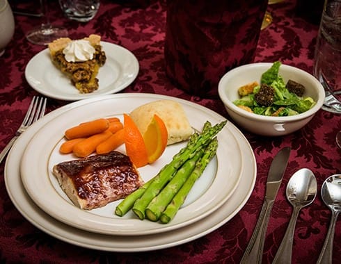 Plated meal with vegetables and dessert on a dining table