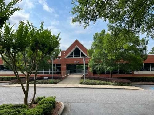 Exterior view of a senior living facility with trees