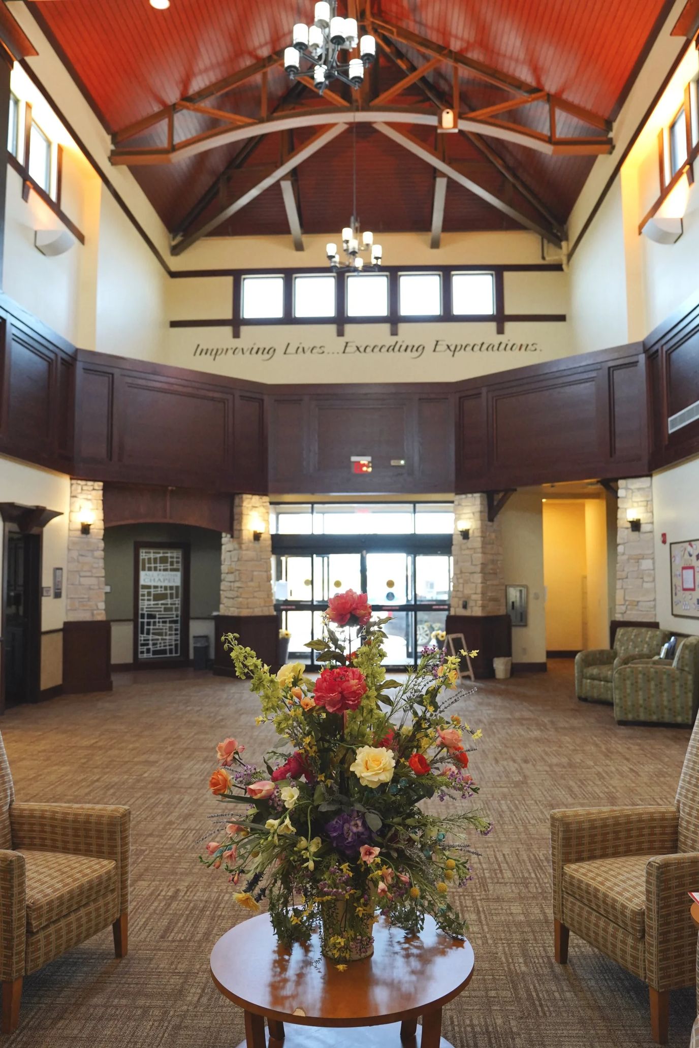 Bright and welcoming lobby with flowers and seating.