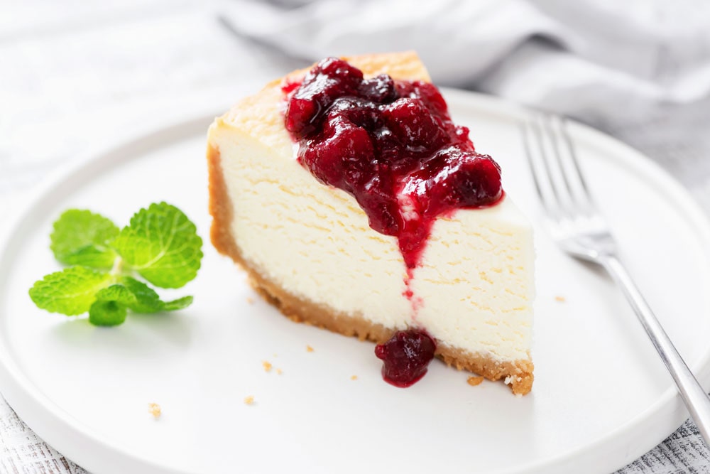 Slice of cheesecake topped with berries