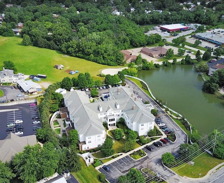 Aerial view of a senior living facility by a lake