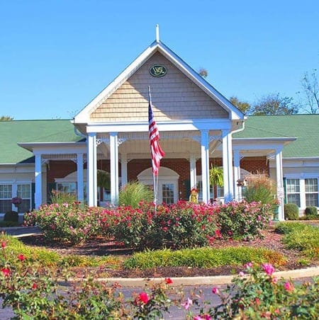 Exterior view of Windsor Gardens with flower beds