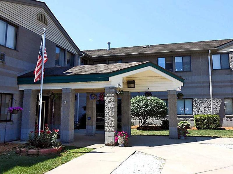 Exterior view of Woodridge Village entrance with landscaping