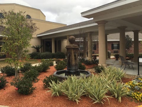 Heritage Manor of Opelousas, Nursing Home in Opelousas, LA — Beautiful outdoor garden area with a fountain