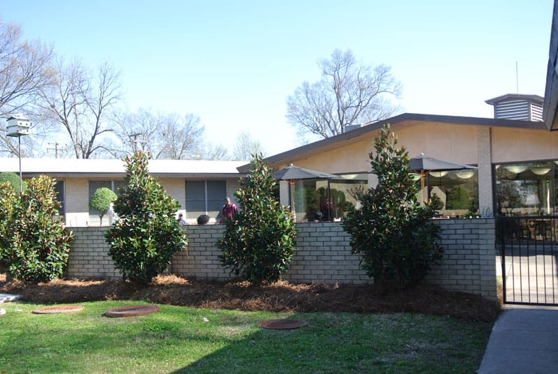 Exterior view of the nursing home building with surrounding greenery