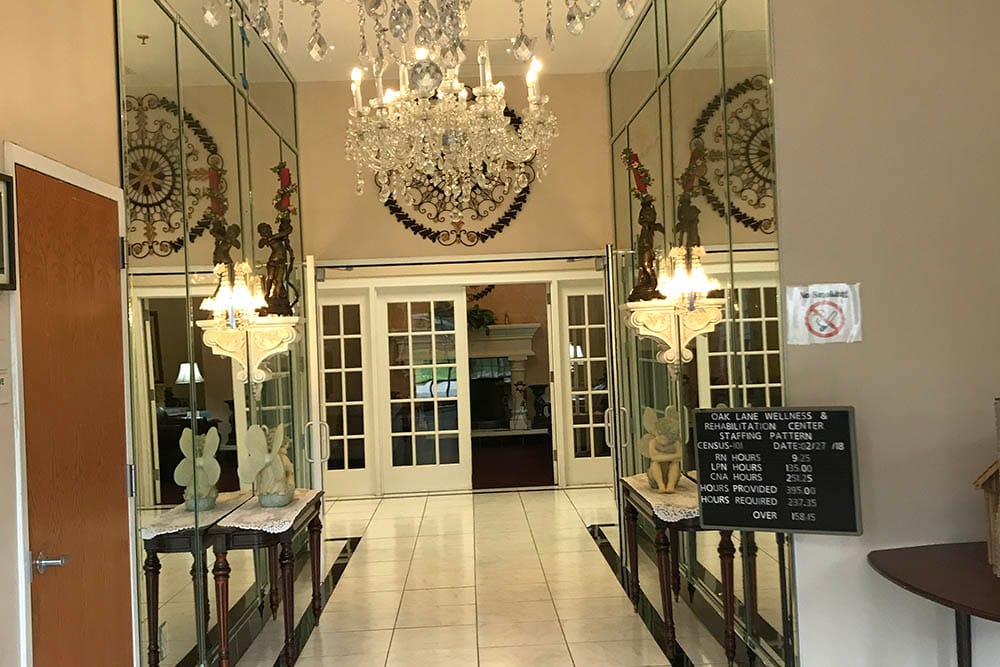 Elegant entrance hall with chandelier and large mirrors