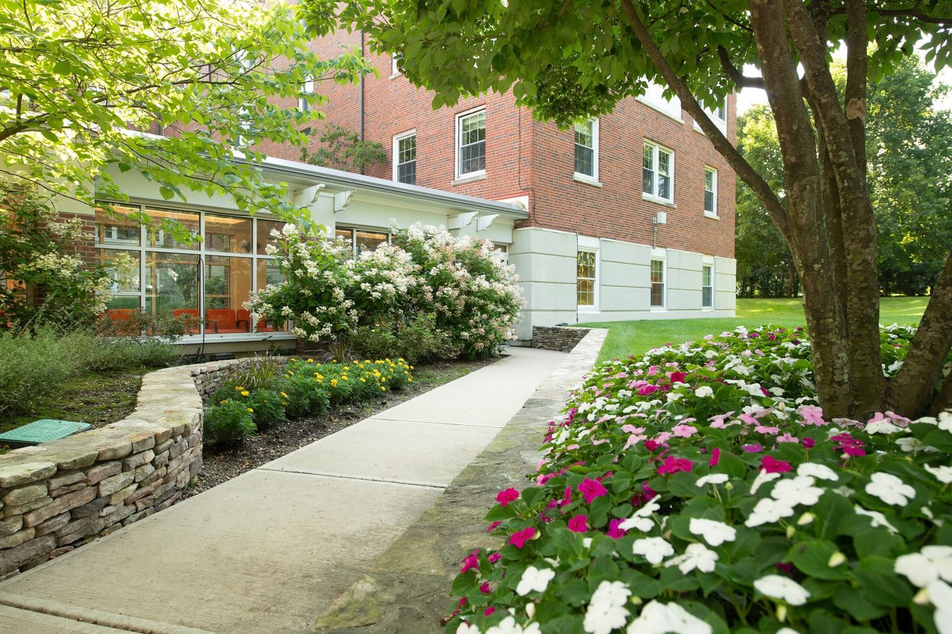 Pathway leading to the facility entrance with flowers