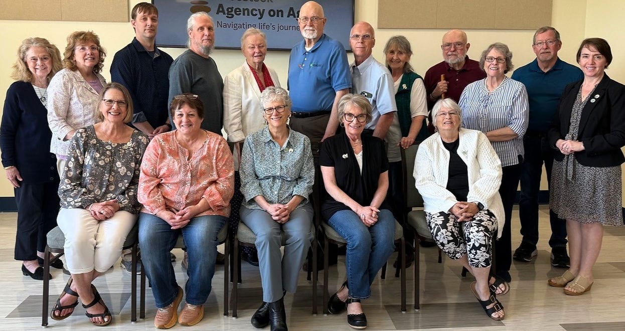 Group photo of staff and members in a common area