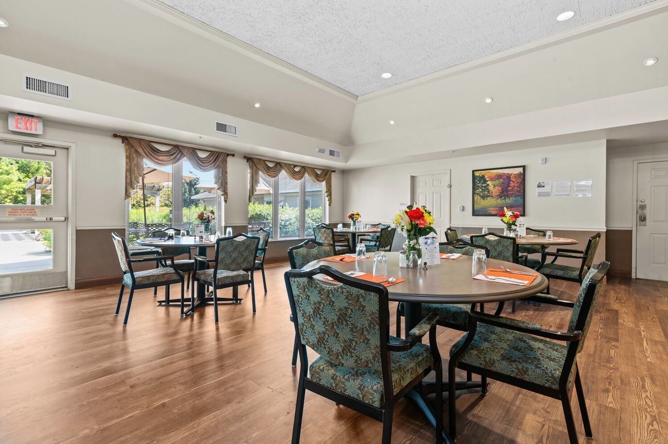 Dining area with tables and flowers in a senior living facility
