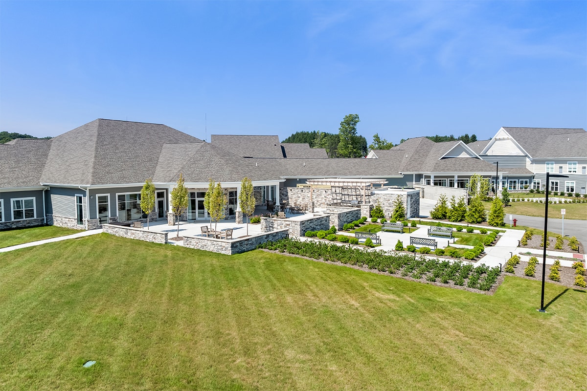 Aerial view of a senior living facility with landscaped gardens