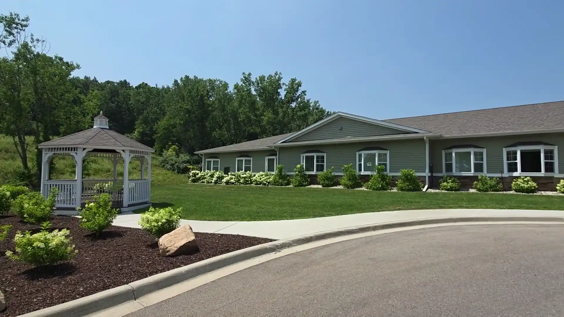 Exterior view of a senior living facility with landscaped garden