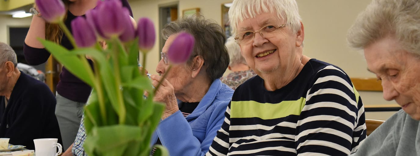 Residents enjoying a social gathering with flowers