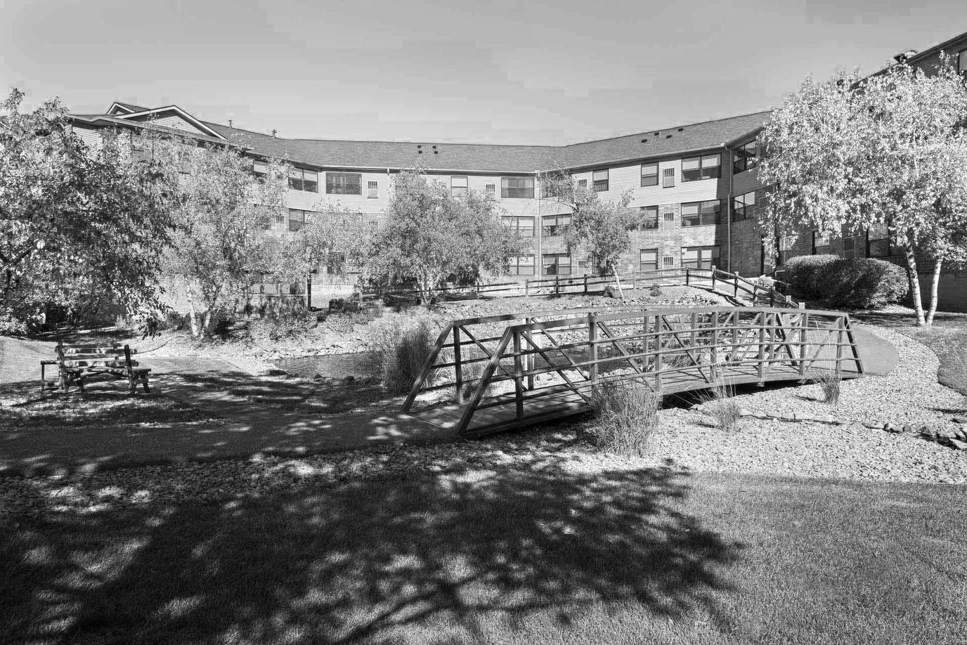 Bridge over a landscaped garden area at the facility