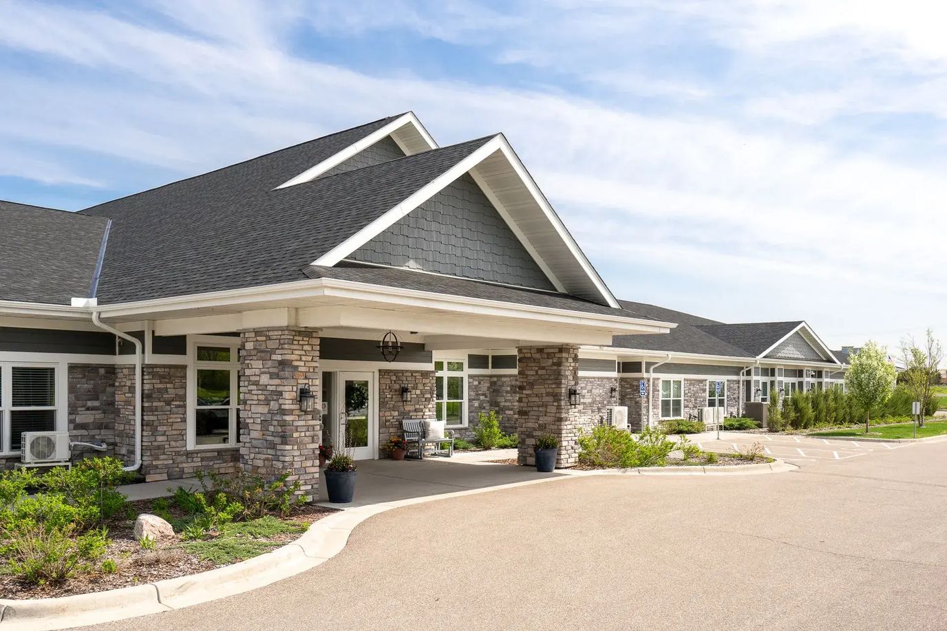Front entrance of a senior living facility with landscaping