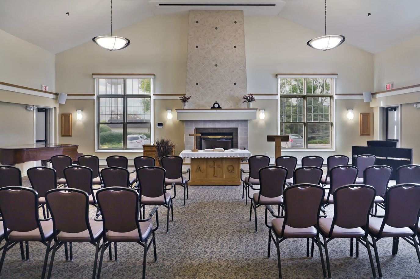 Interior view of a common area with chairs and a fireplace