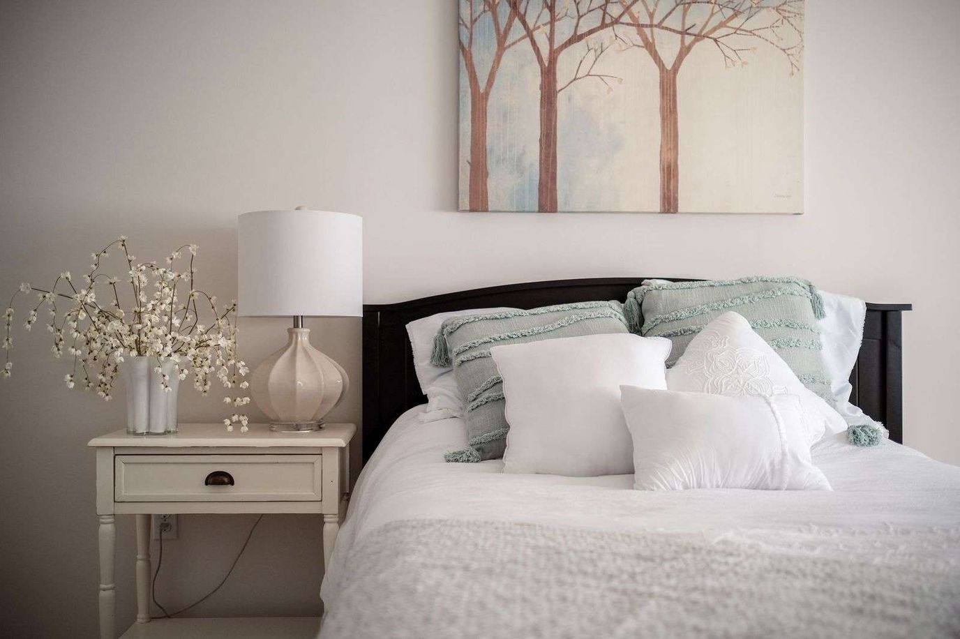 Cozy bedroom with decorative pillows and a lamp