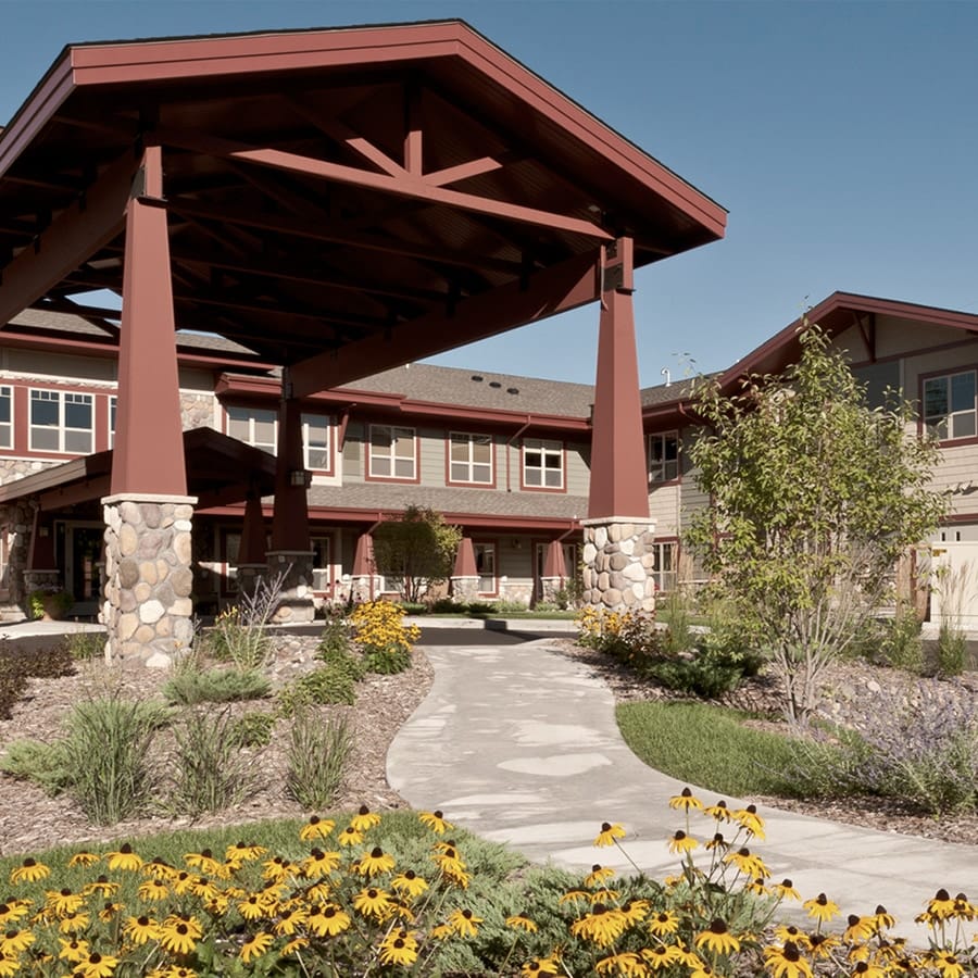 Exterior view of a senior living facility with landscaping