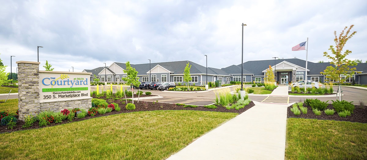 Exterior view of The Courtyard at Delta with gardens and pathway
