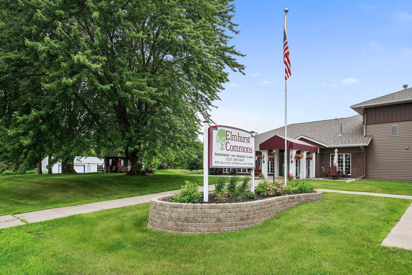 Exterior view of Elmhurst Commons Apartments with landscaping