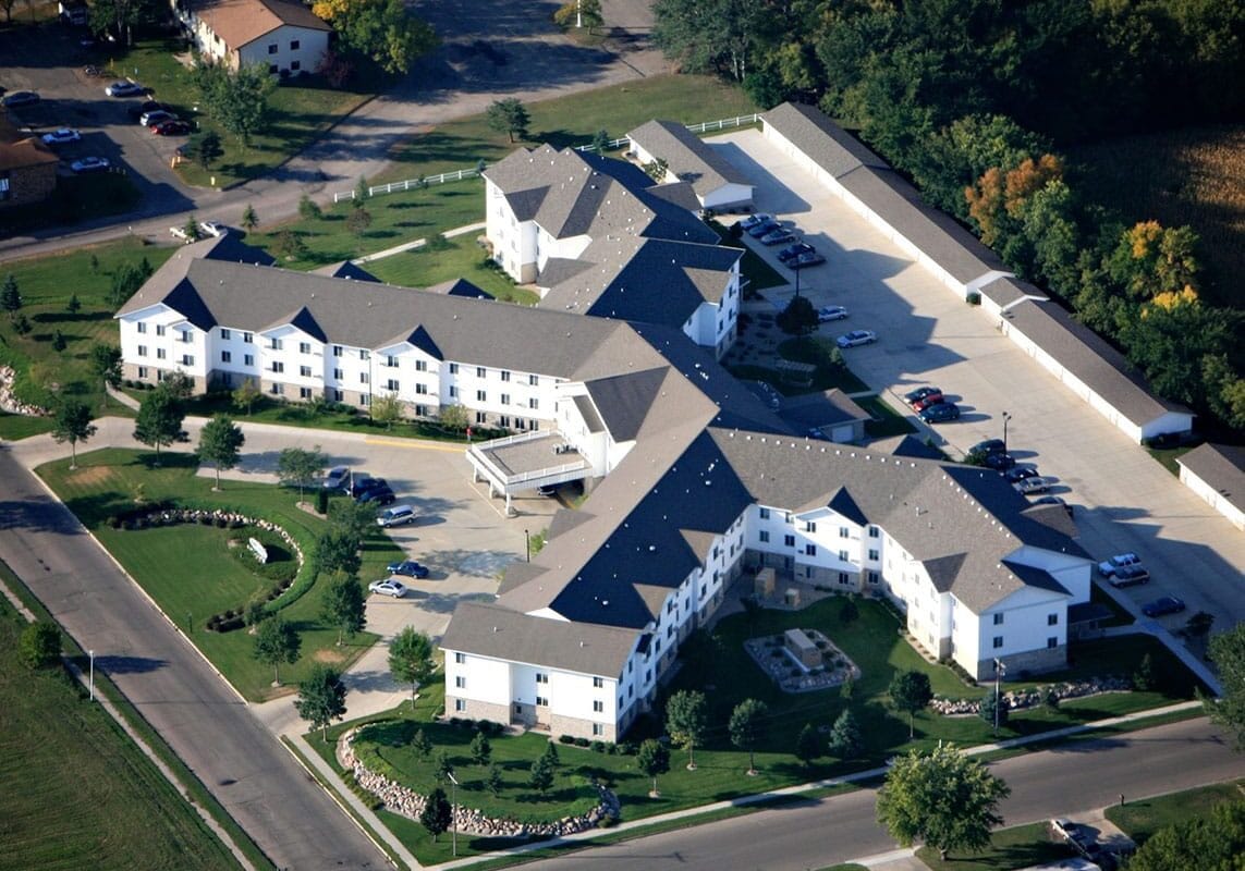 Aerial view of a senior living facility with landscaped grounds