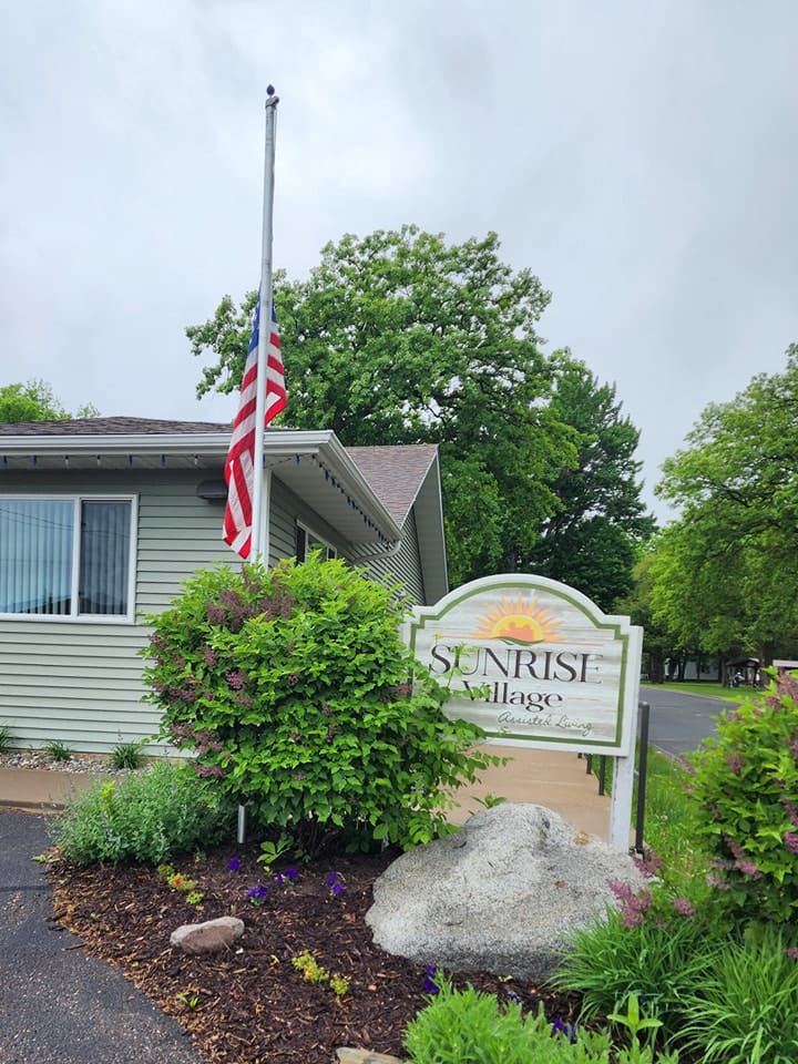 Exterior view of Sunrise Village building with American flag