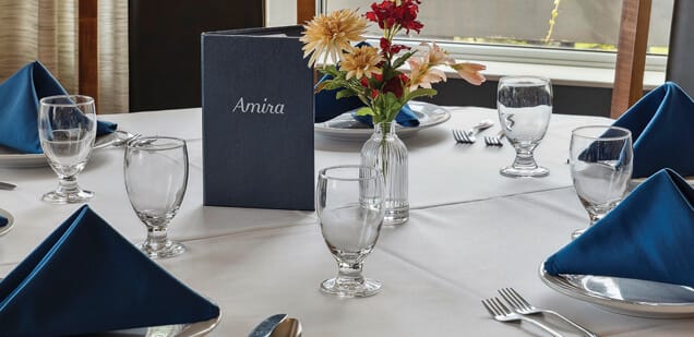 Dining table set with menu and flowers