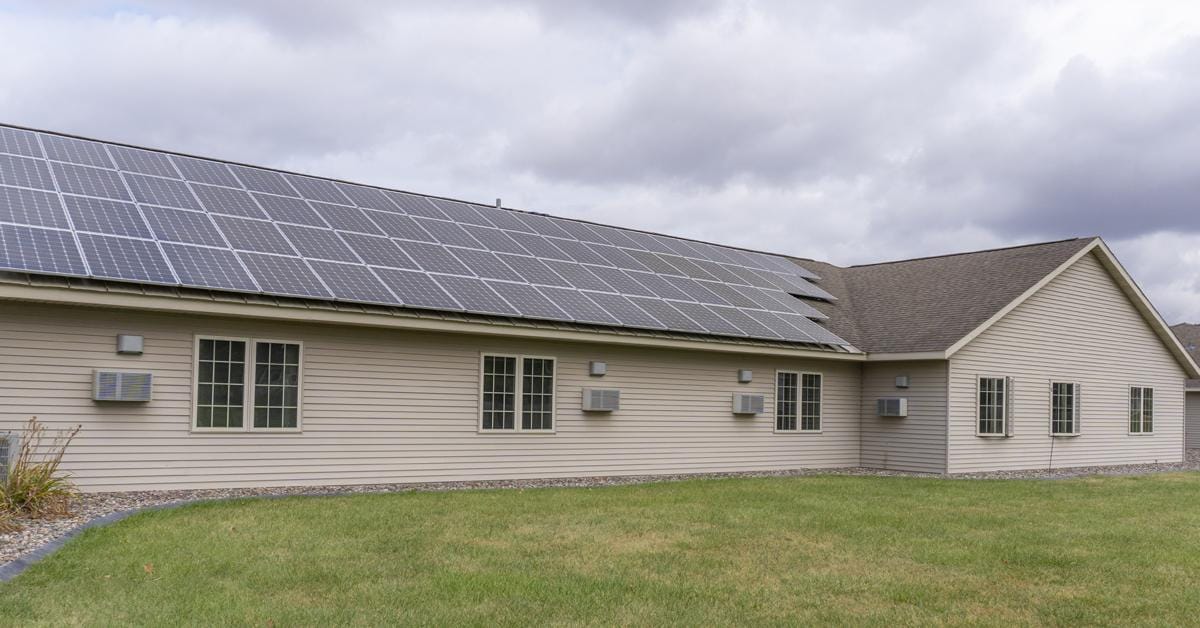 Exterior view of a retirement community building with solar panels