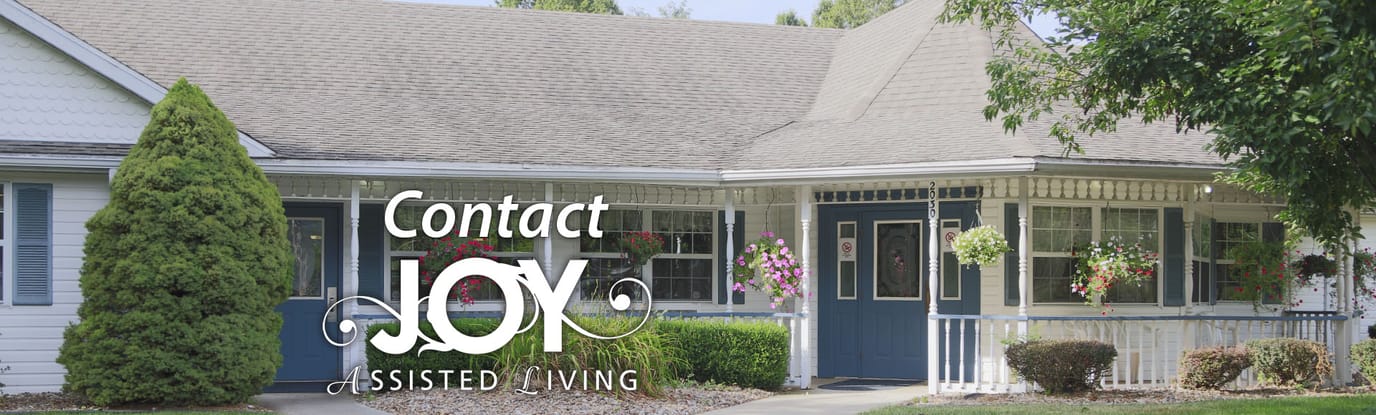 Exterior view of Joy Assisted Living building with logo