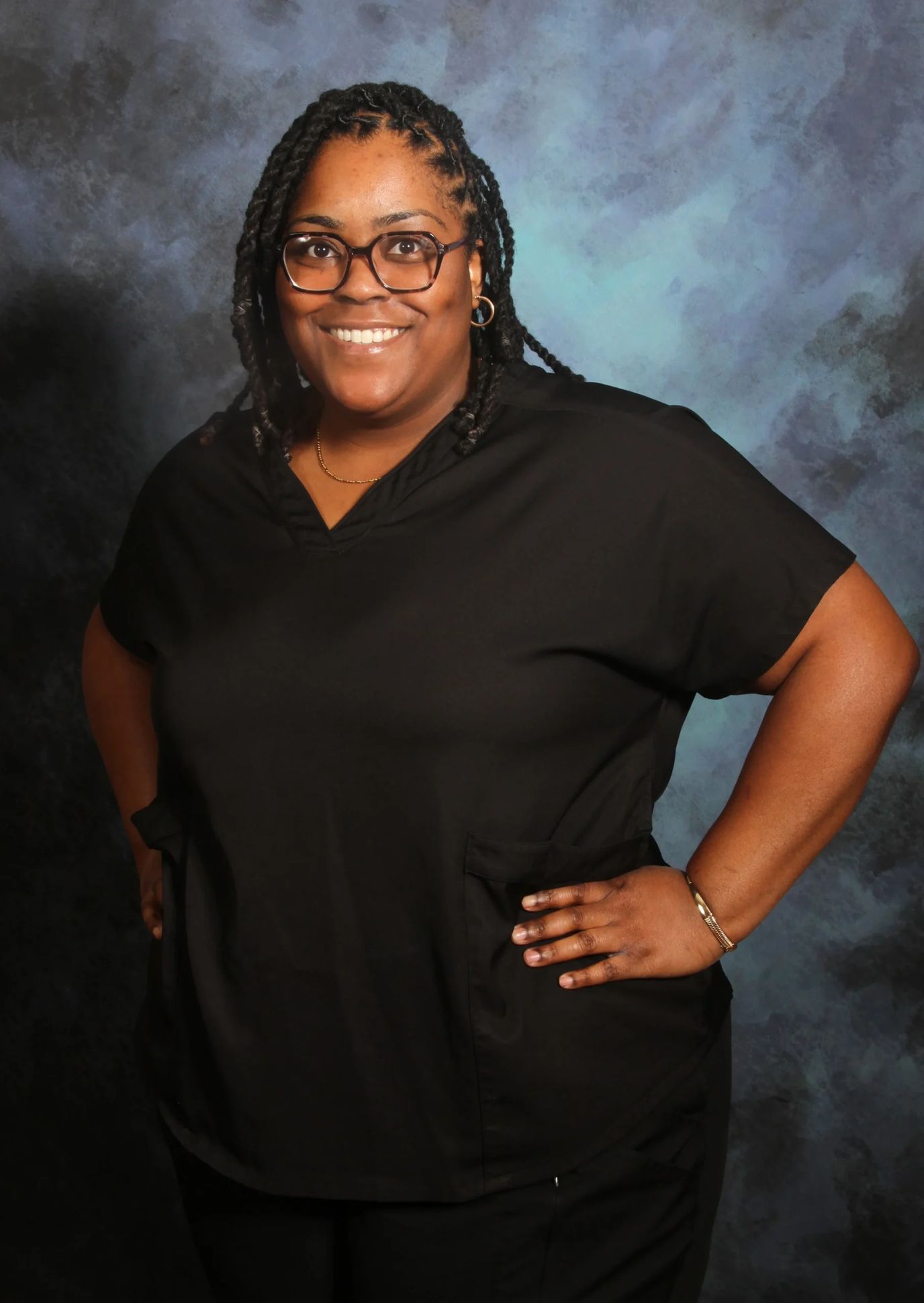 Smiling staff member in black uniform.