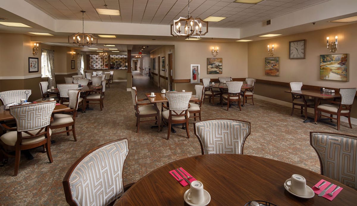 Dining area with tables and chairs for residents.