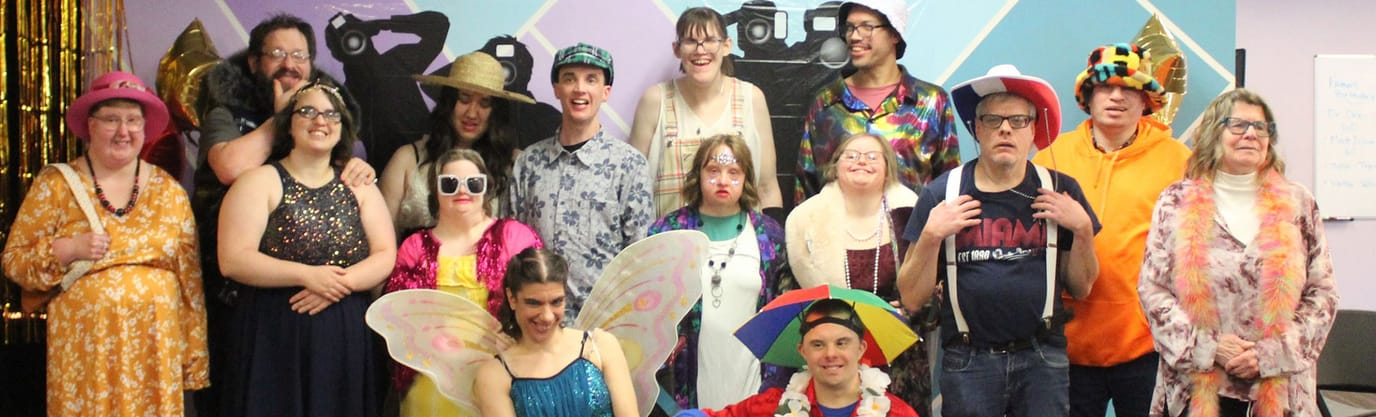 Group of residents in festive costumes at an event.
