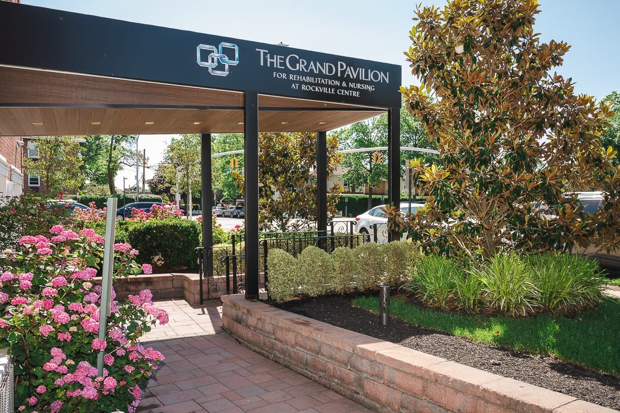 Entrance to The Grand Pavilion with flowers and landscaping