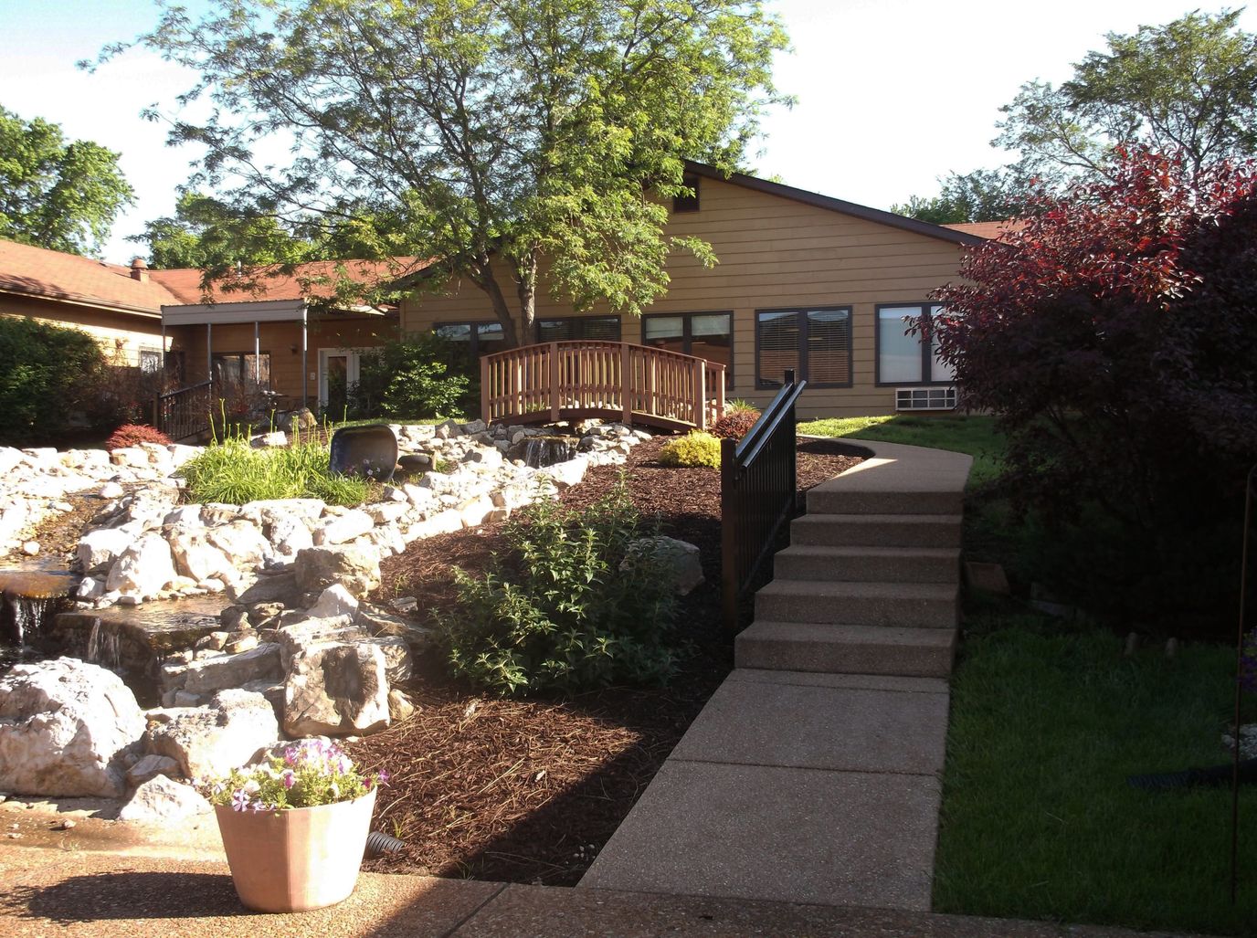 Pathway leading to the entrance of the facility with landscaped garden