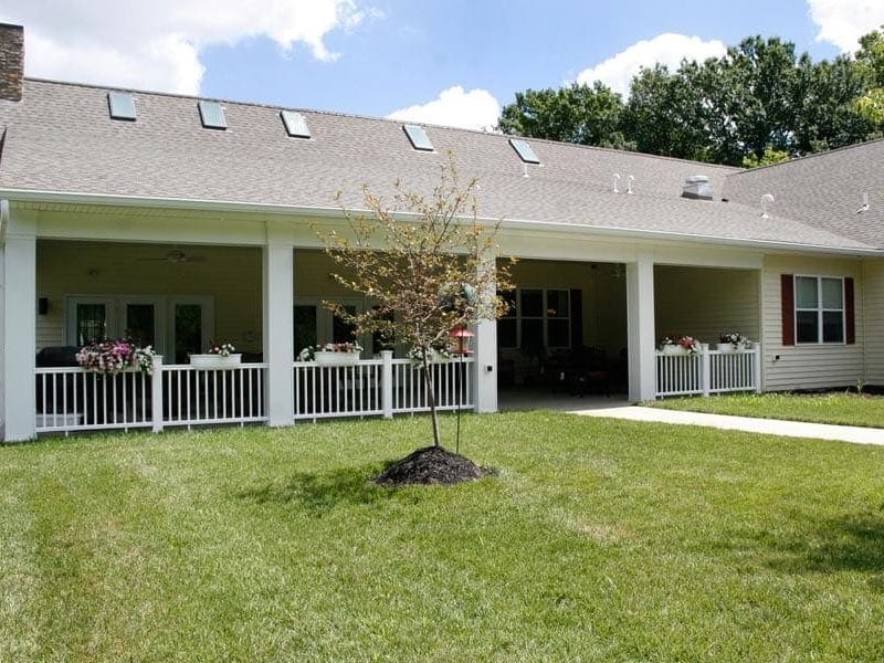 Exterior view of a senior living building with a porch