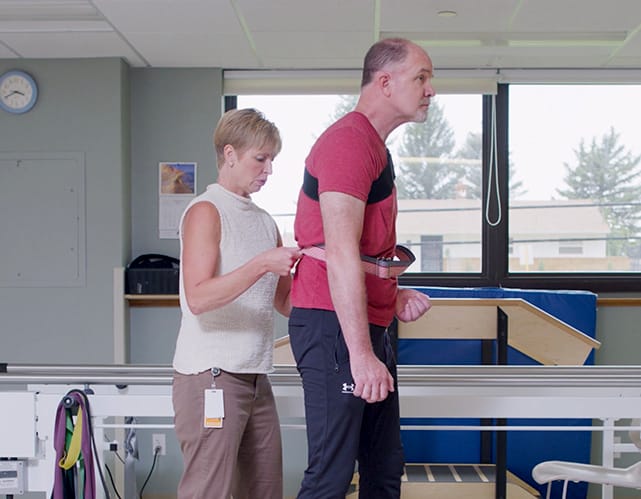Therapist assisting resident in a rehabilitation session