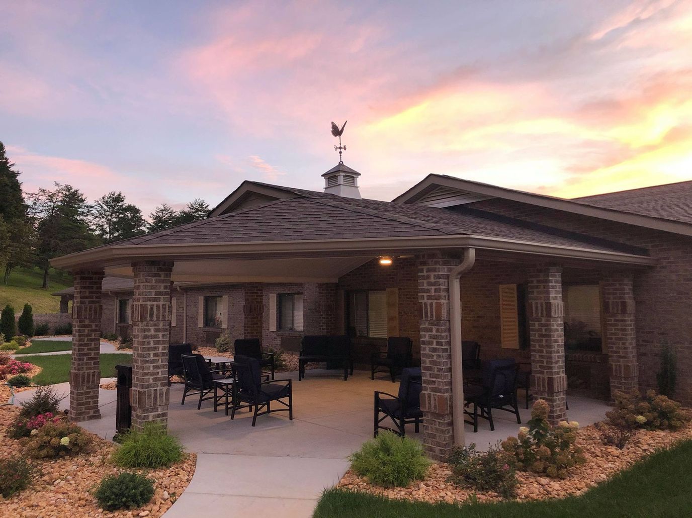 Covered patio area with seating and landscaping