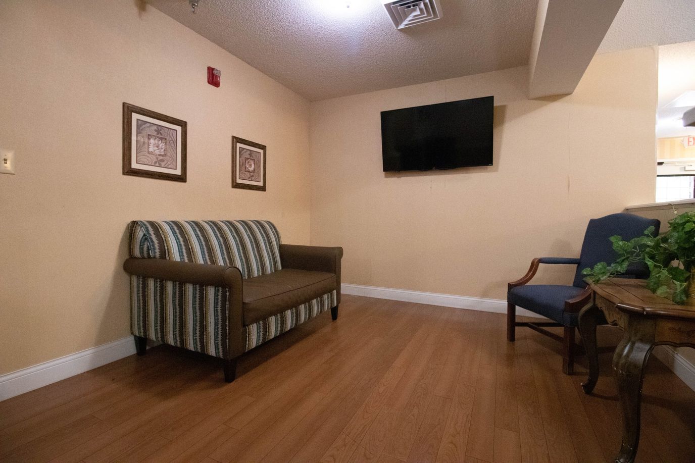 Hayesville House, memory care in Hayesville, NC — Seating area with couch, chair, and television