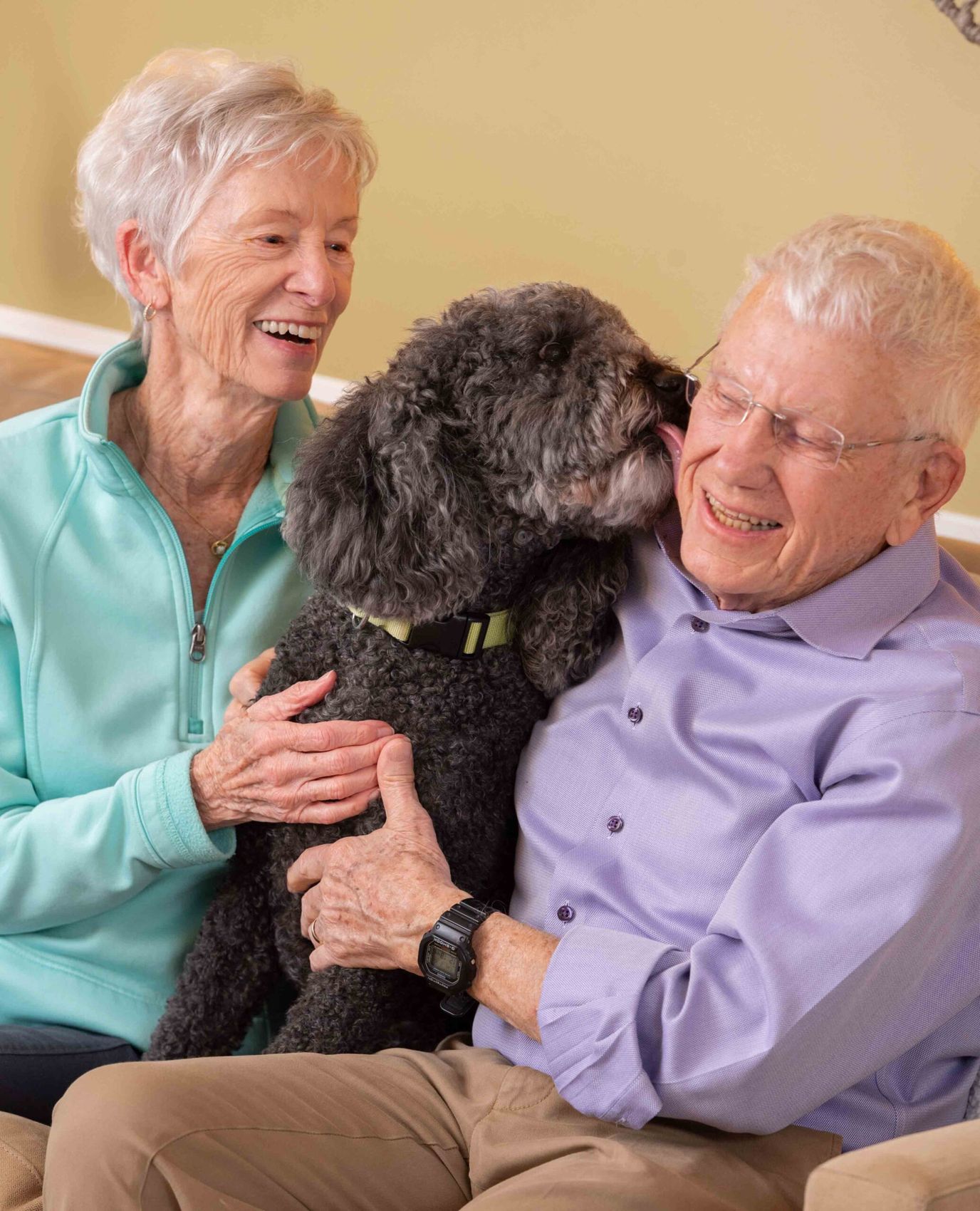 Residents enjoying time with a dog in a cozy setting