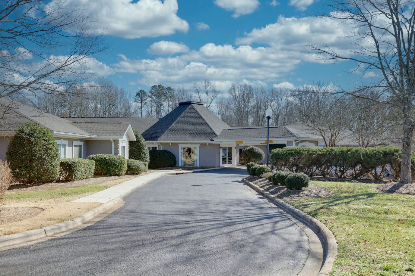 Entrance view of Mint Hill Senior Living with landscaping